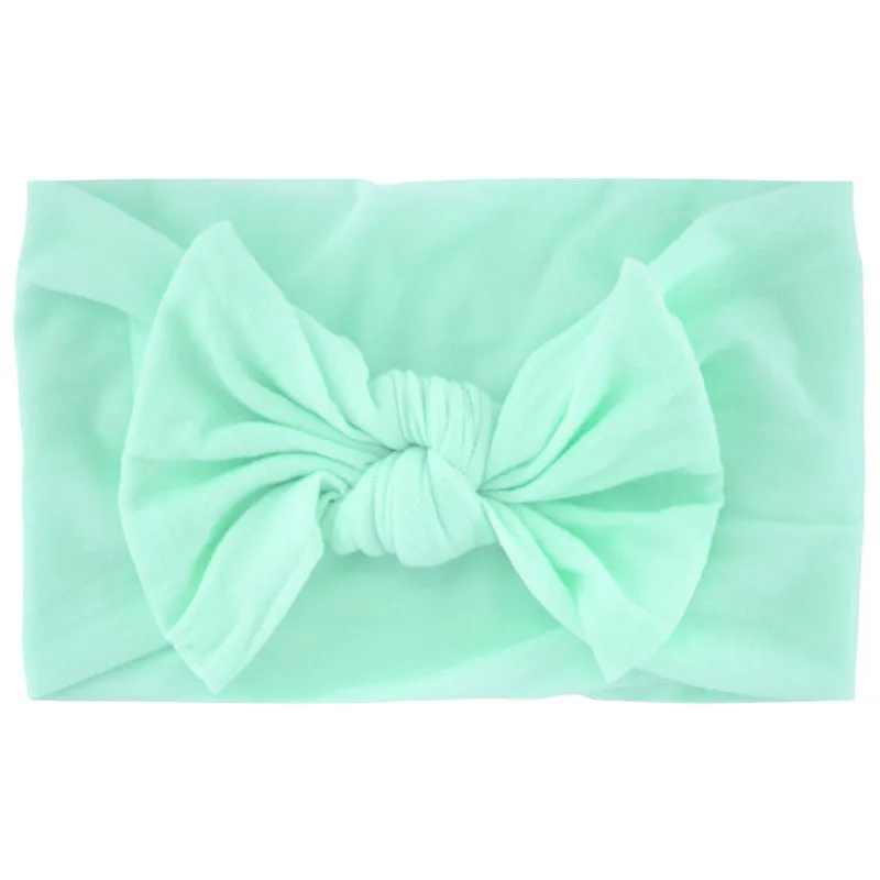 Super stretchy soft knot headband with hair bow for baby girls in one of 22 colours