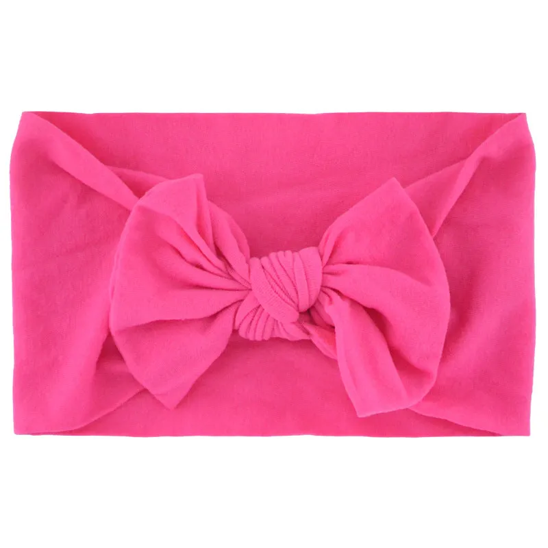 Super stretchy soft knot headband with hair bow for baby girls in one of 22 colours