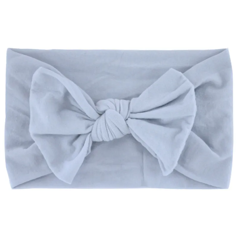 Super stretchy soft knot headband with hair bow for baby girls in one of 22 colours