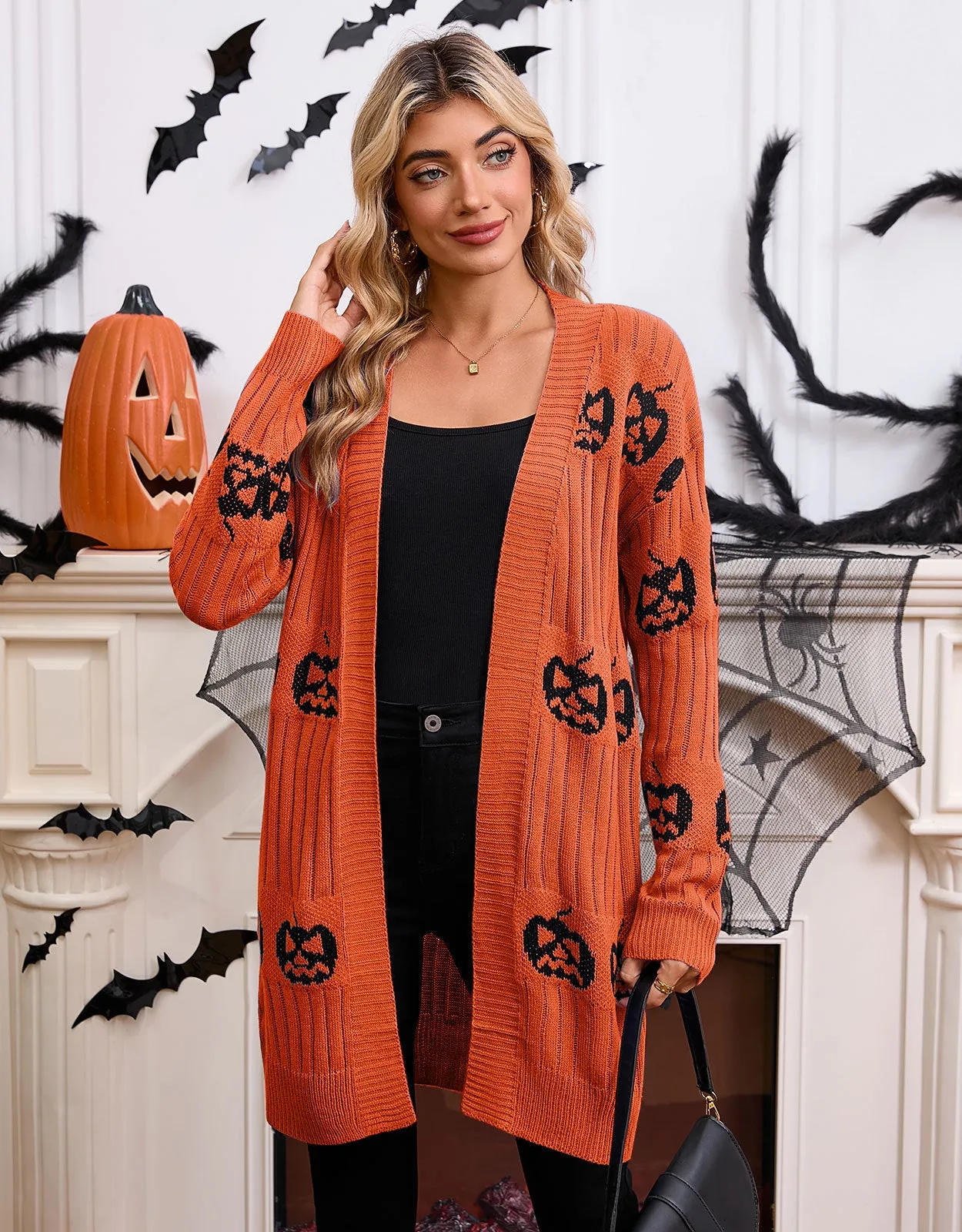 Women's black cardigan with orange knitted pumpkin head jacquard pattern.