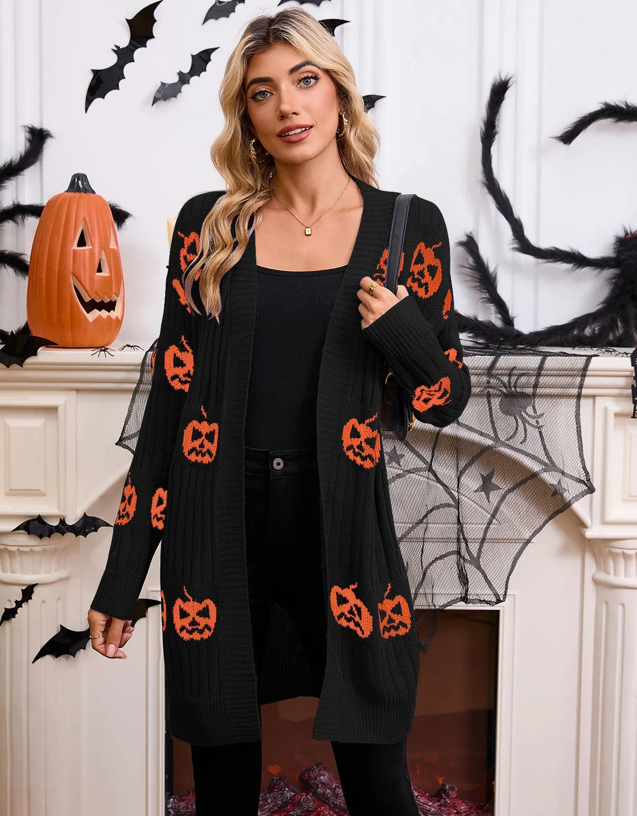 Women's black cardigan with orange knitted pumpkin head jacquard pattern.