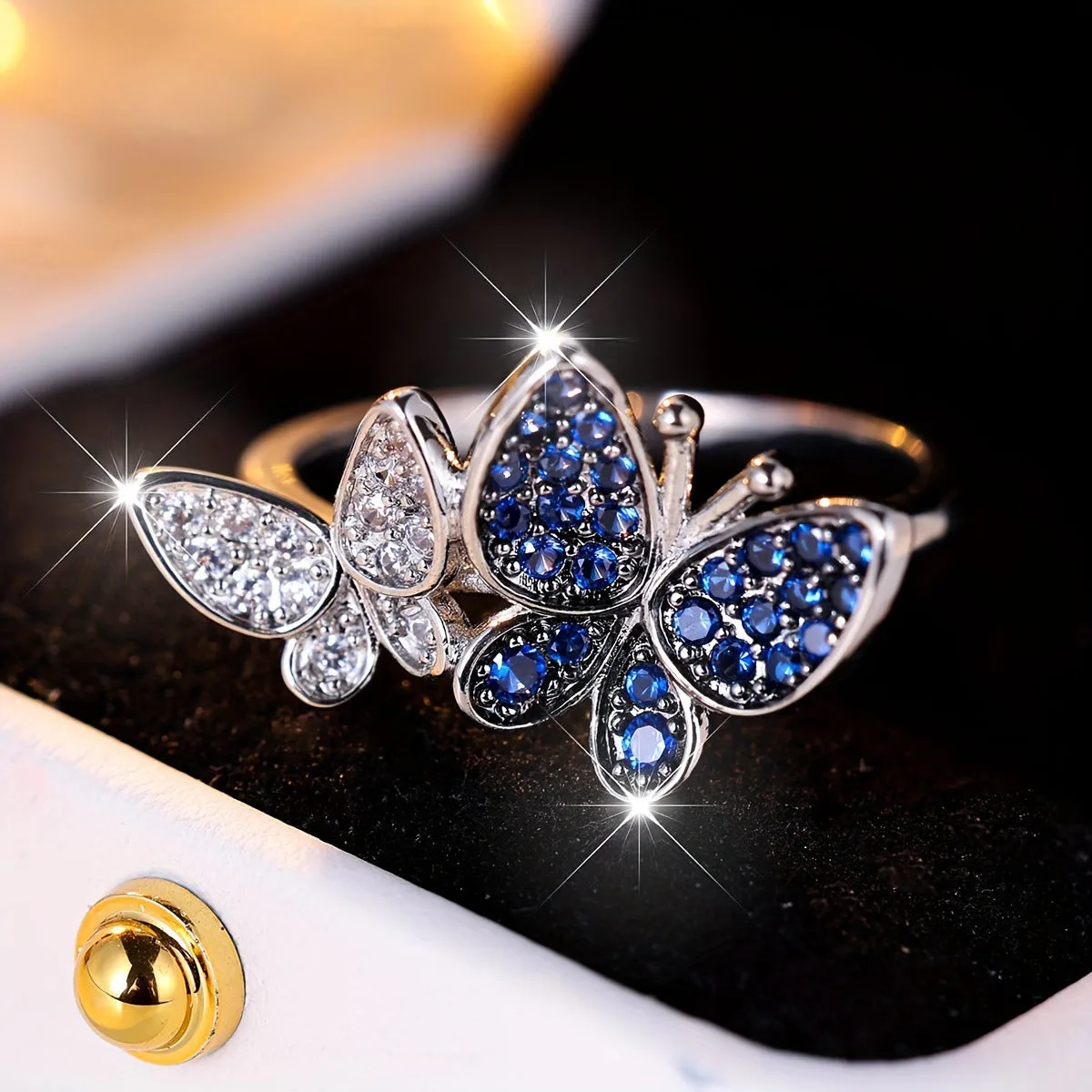 Blue and white butterfly design ring for women on a copper band, showing side detail.