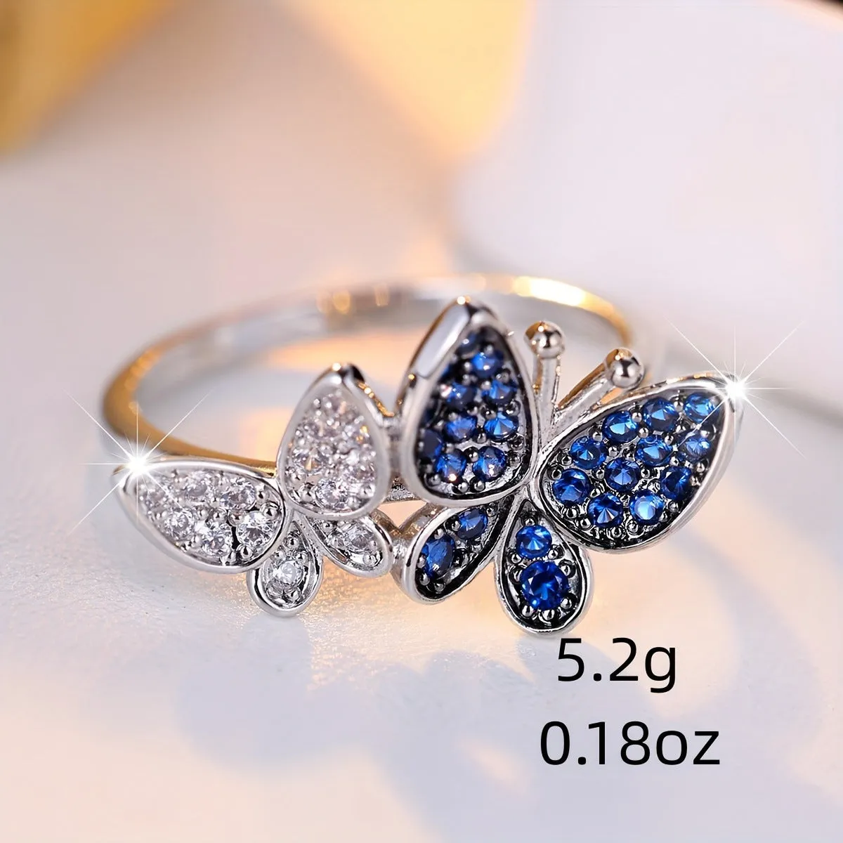 Blue and white butterfly design ring for women on a copper band, showing side detail.