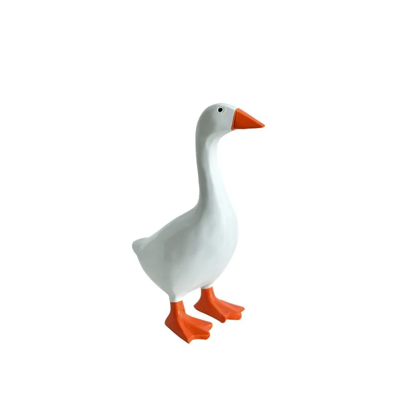 White simulation duck resin magnetic ornament on metal surface holding a note