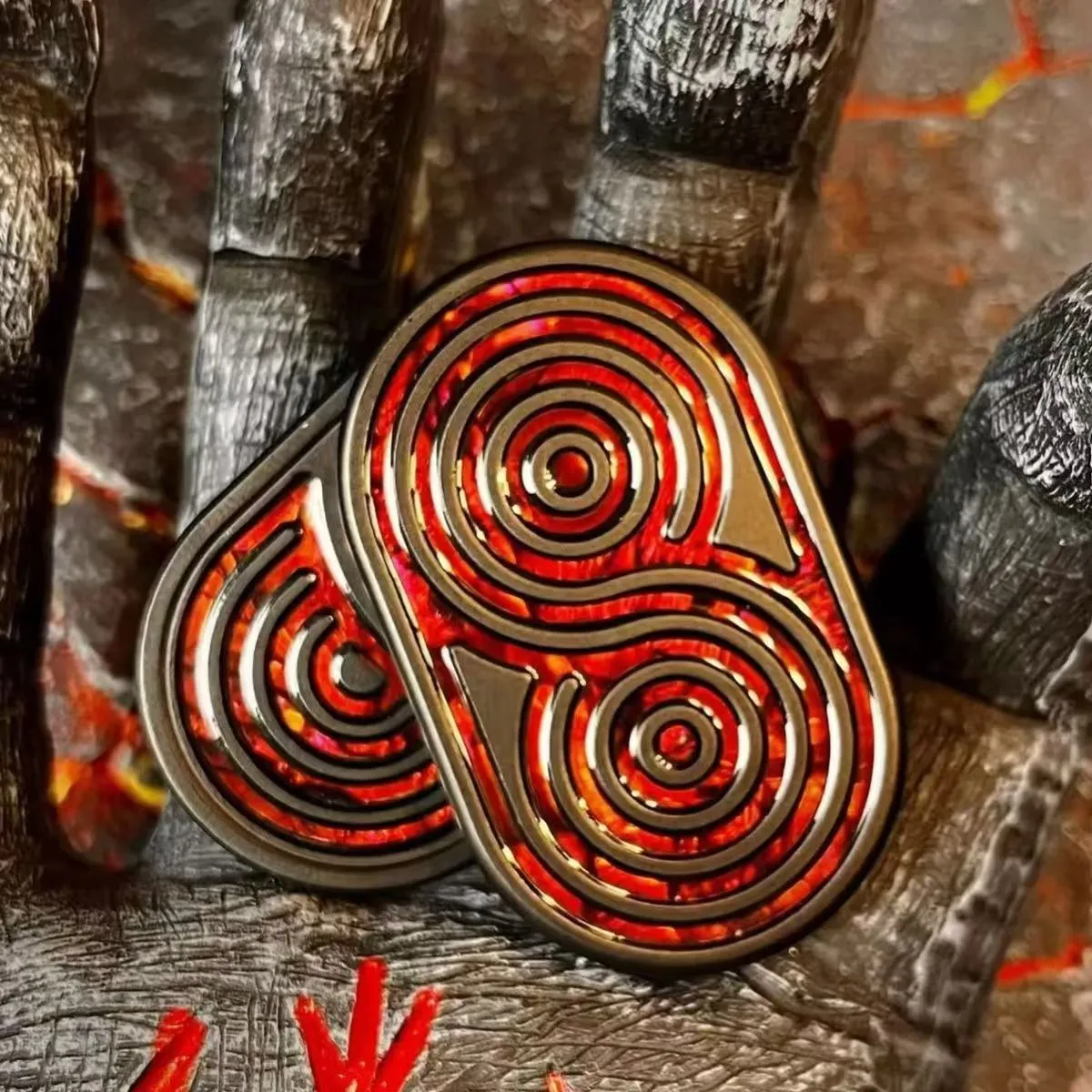 Stainless steel EDC hand push coin in agate red colour on plain background