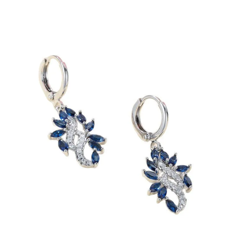 A pair of platinum sapphire blue alloy drop dangle earrings for women on a plain background.