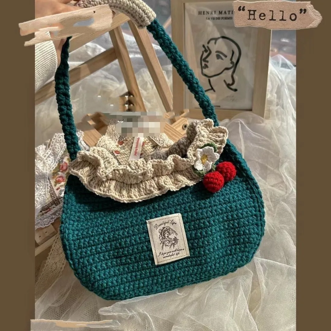 Wool crocheted bear shoulder bag with wooden handle and adjustable strap in one of four decorative styles