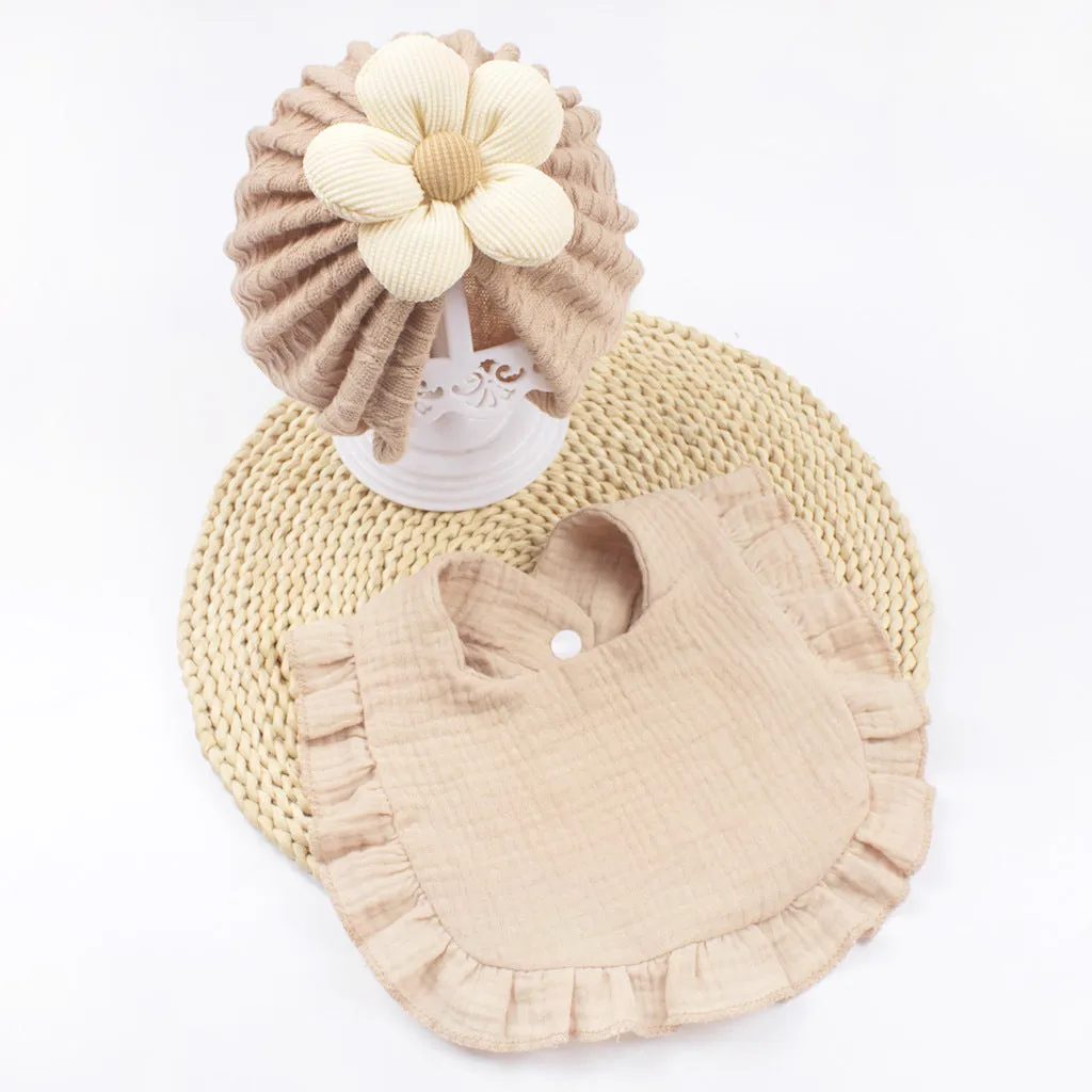 Newborn baby hat and bib set in organic cotton muslin with frilly lace trim