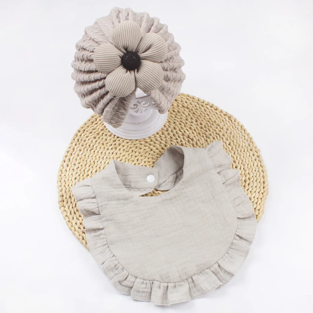 Newborn baby hat and bib set in organic cotton muslin with frilly lace trim