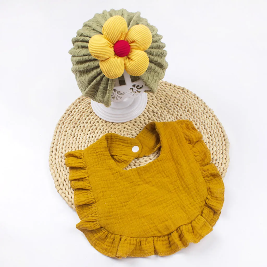 Newborn baby hat and bib set in organic cotton muslin with frilly lace trim