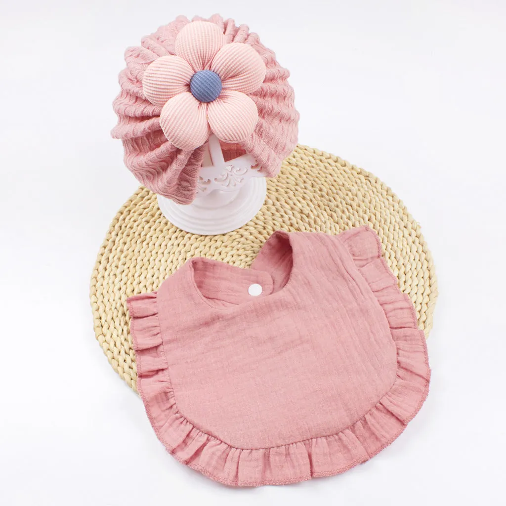 Newborn baby hat and bib set in organic cotton muslin with frilly lace trim