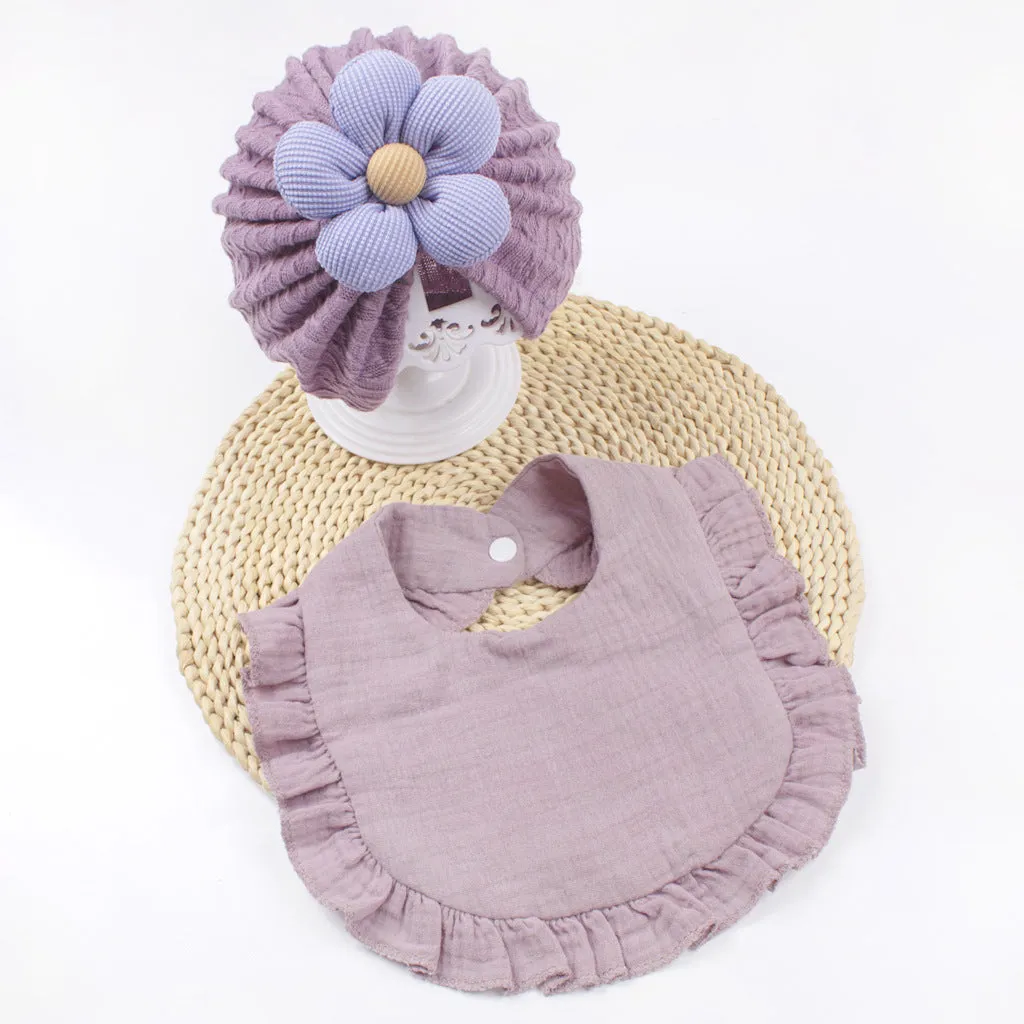 Newborn baby hat and bib set in organic cotton muslin with frilly lace trim