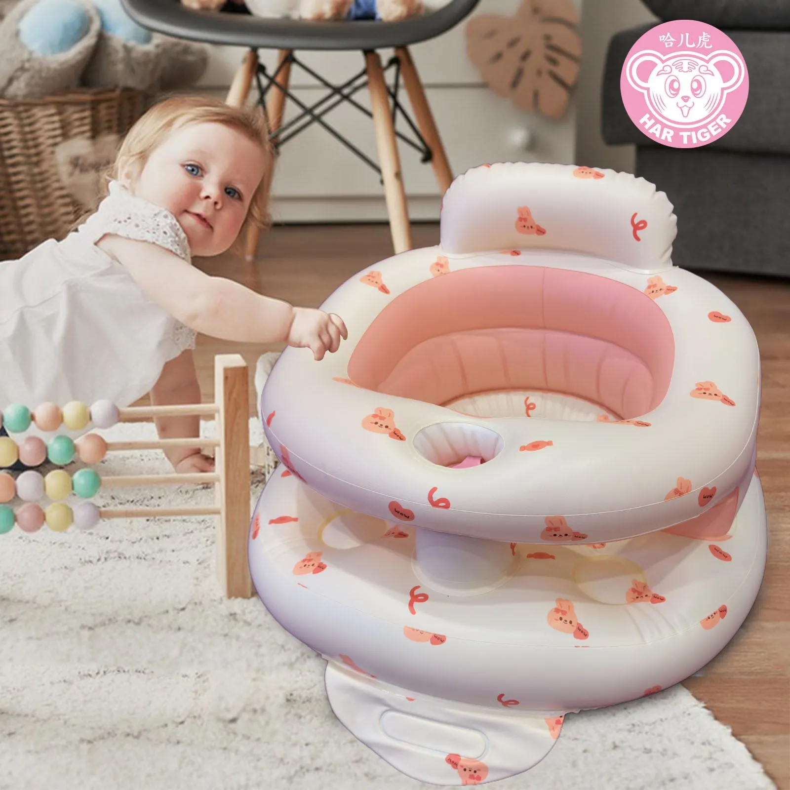 Inflatable infant dining chair in PVC with bear design, deflated beside a baby for scale