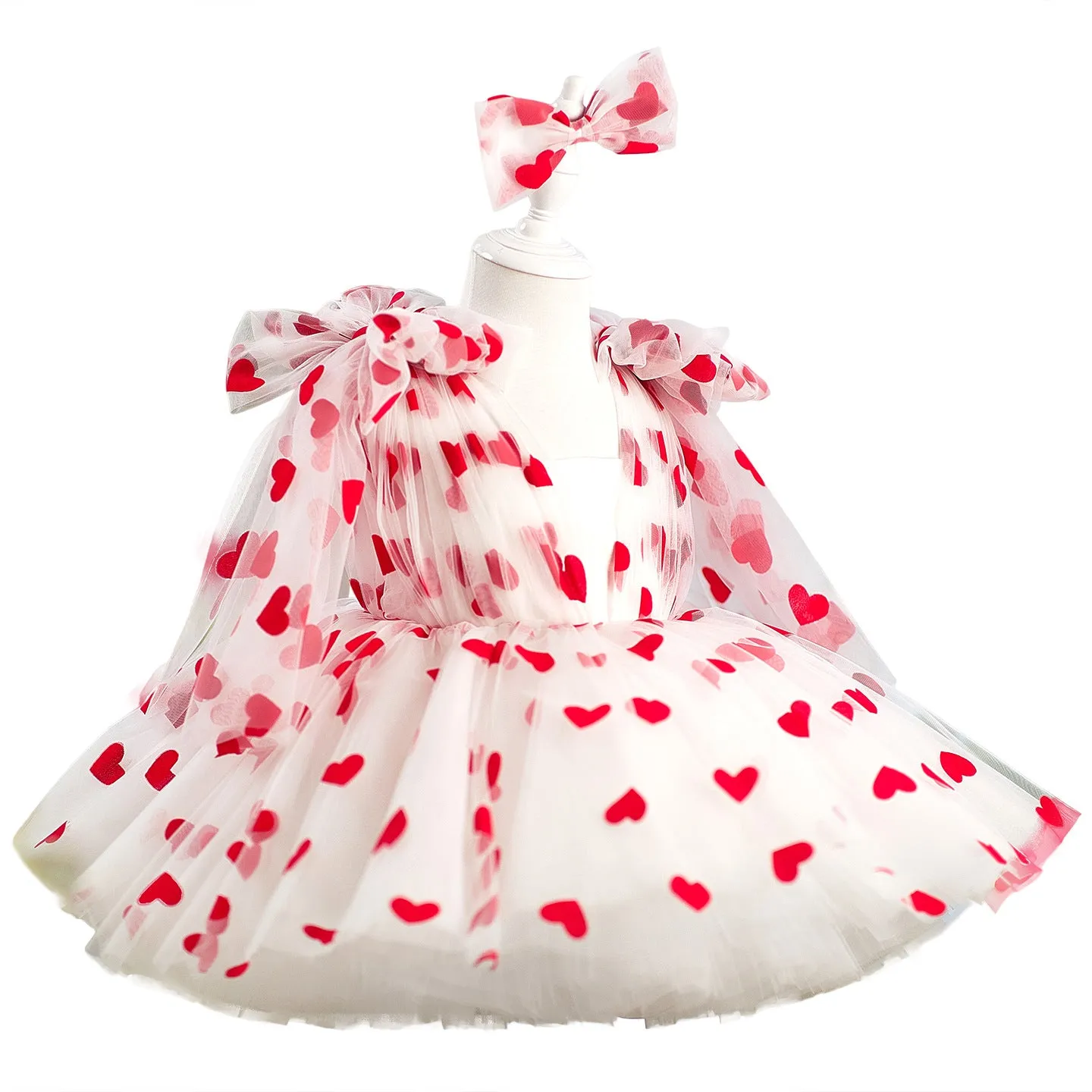 Children red love princess dress gown with heart print on light background, front view