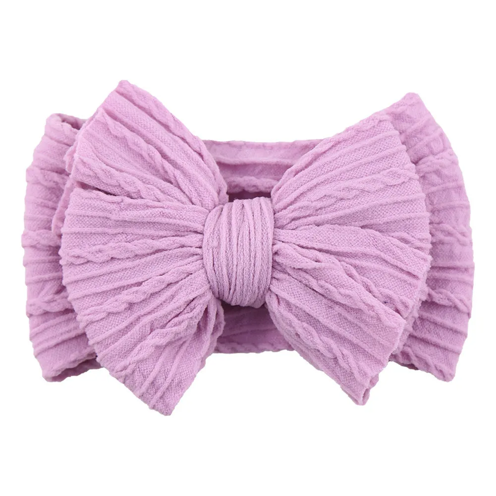 Handmade stretchy nylon baby headband with bow on newborn girl