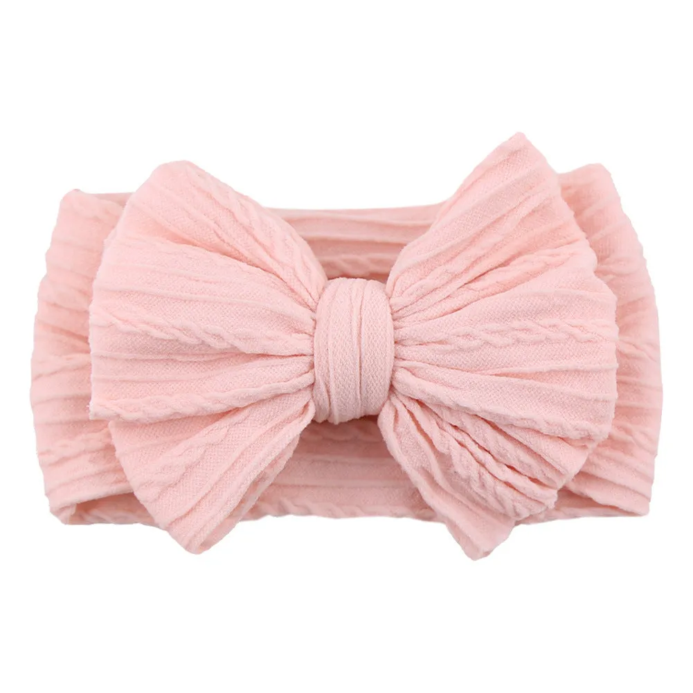 Handmade stretchy nylon baby headband with bow on newborn girl