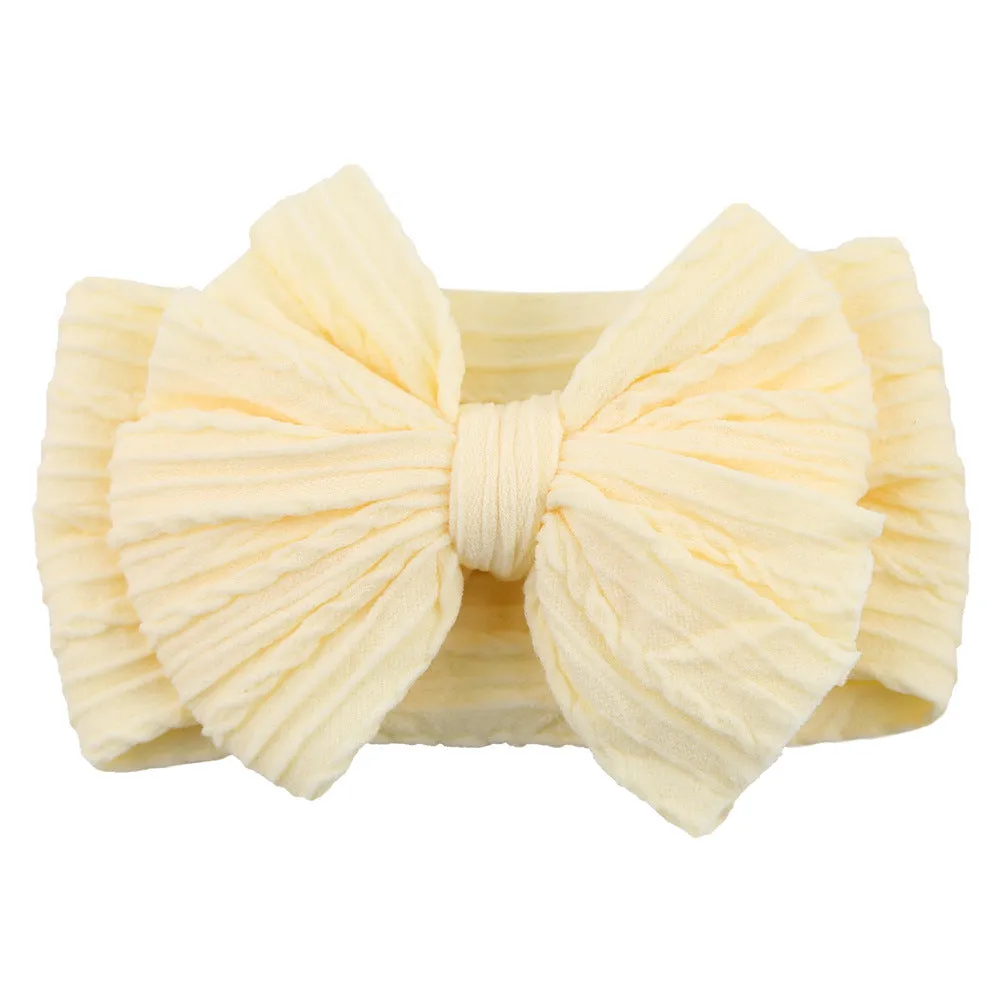 Handmade stretchy nylon baby headband with bow on newborn girl