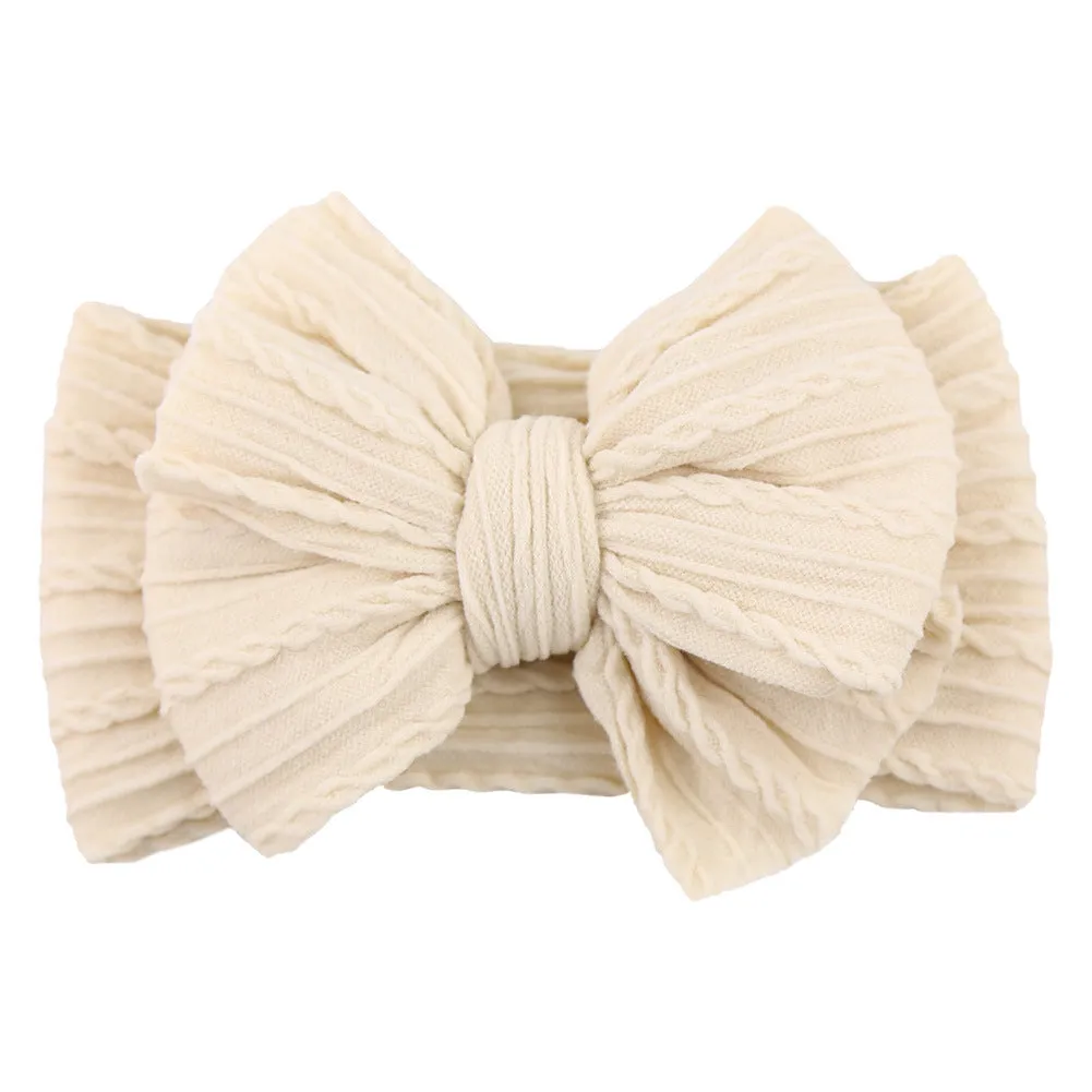 Handmade stretchy nylon baby headband with bow on newborn girl