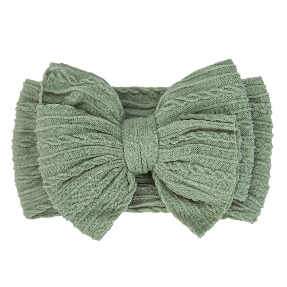 Handmade stretchy nylon baby headband with bow on newborn girl