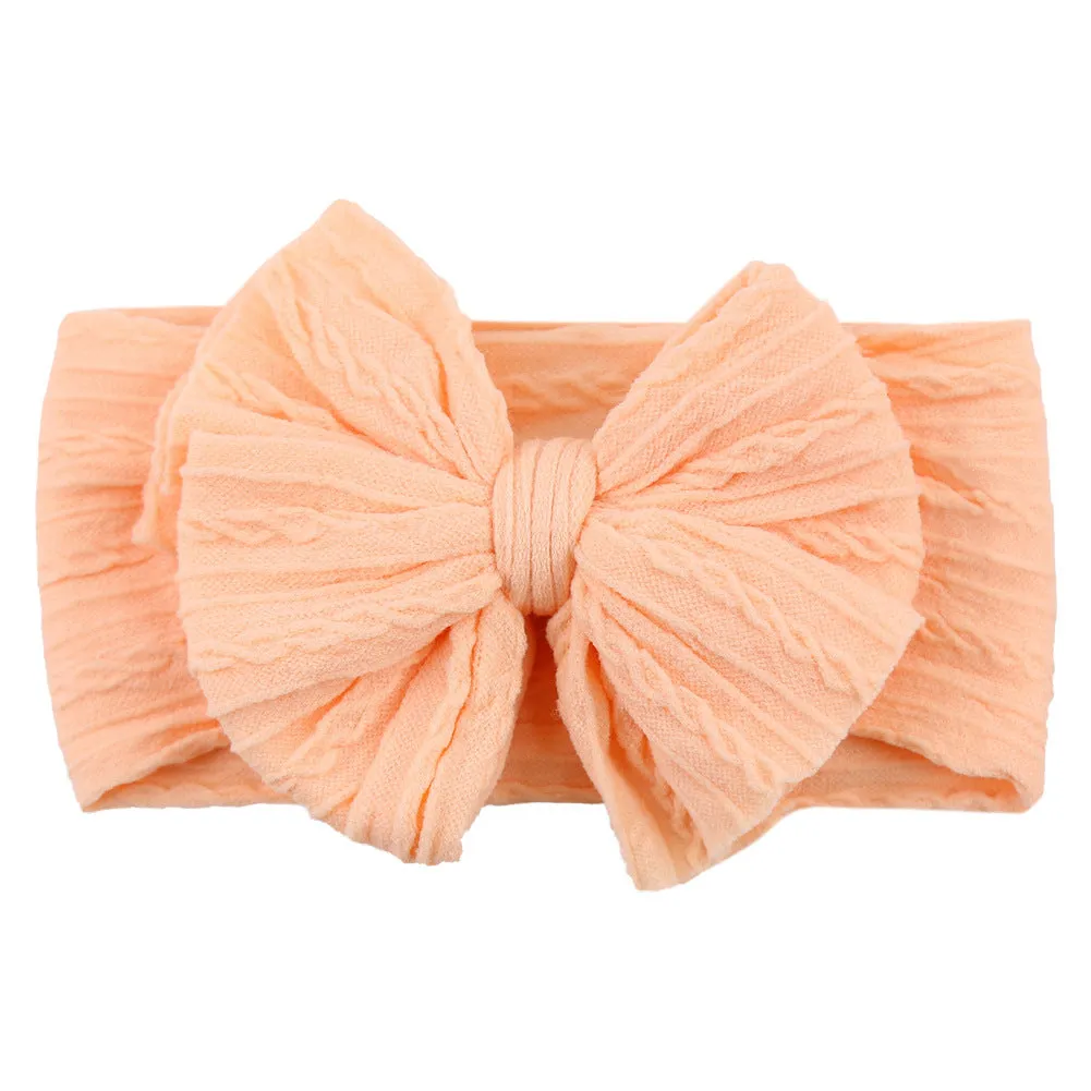 Handmade stretchy nylon baby headband with bow on newborn girl