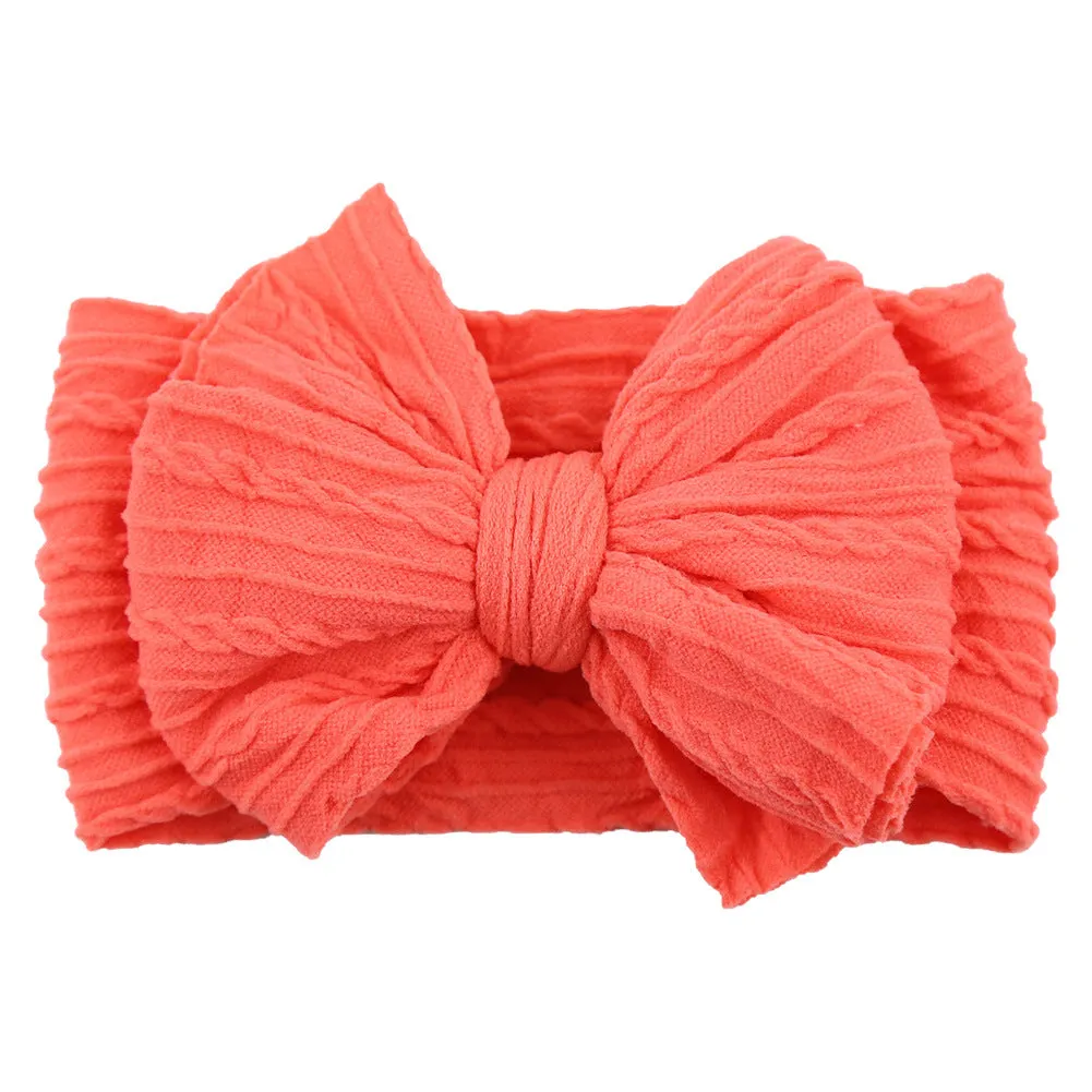 Handmade stretchy nylon baby headband with bow on newborn girl