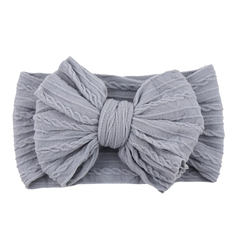 Handmade stretchy nylon baby headband with bow on newborn girl