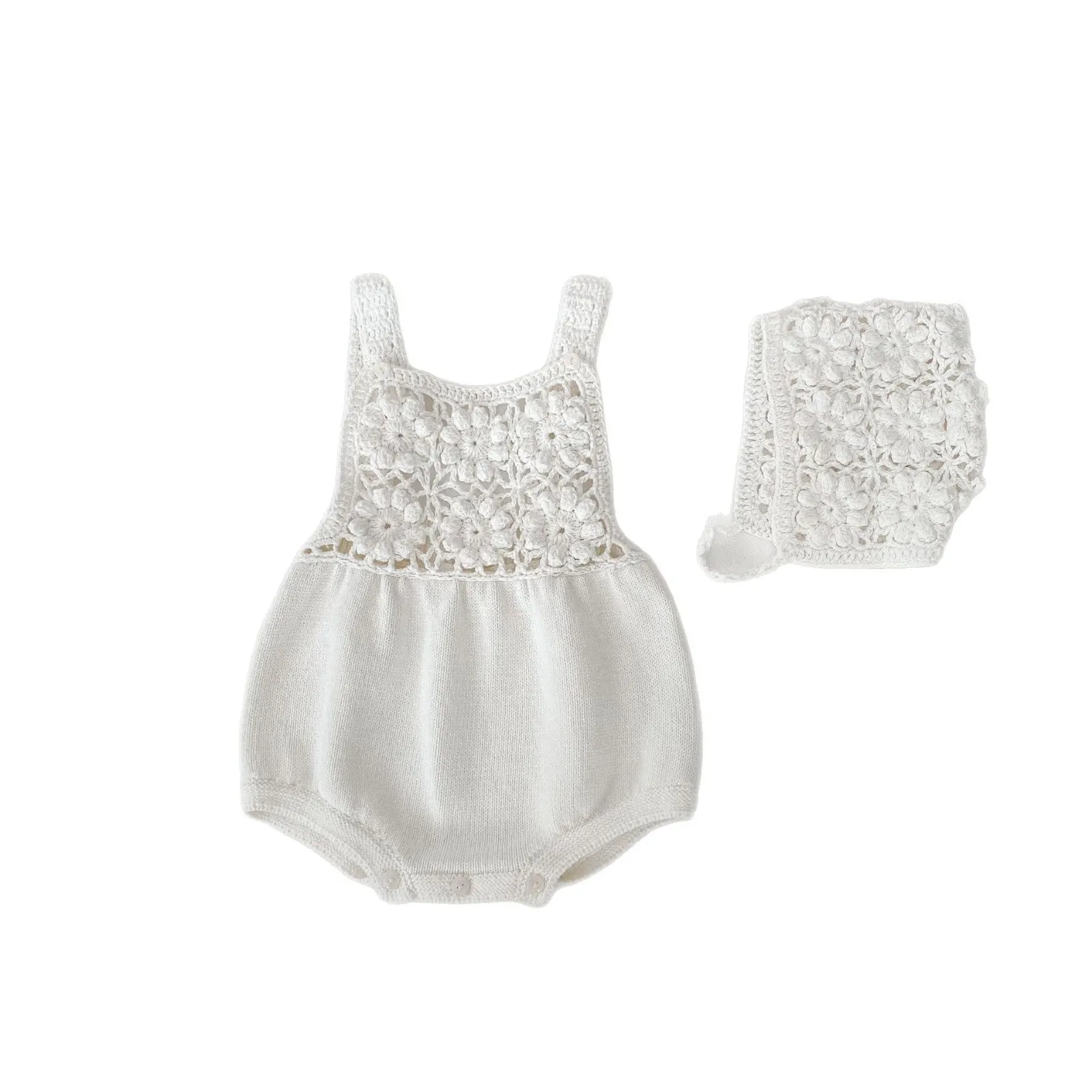 Beige baby romper with flower cutout strap and matching hat on a baby girl