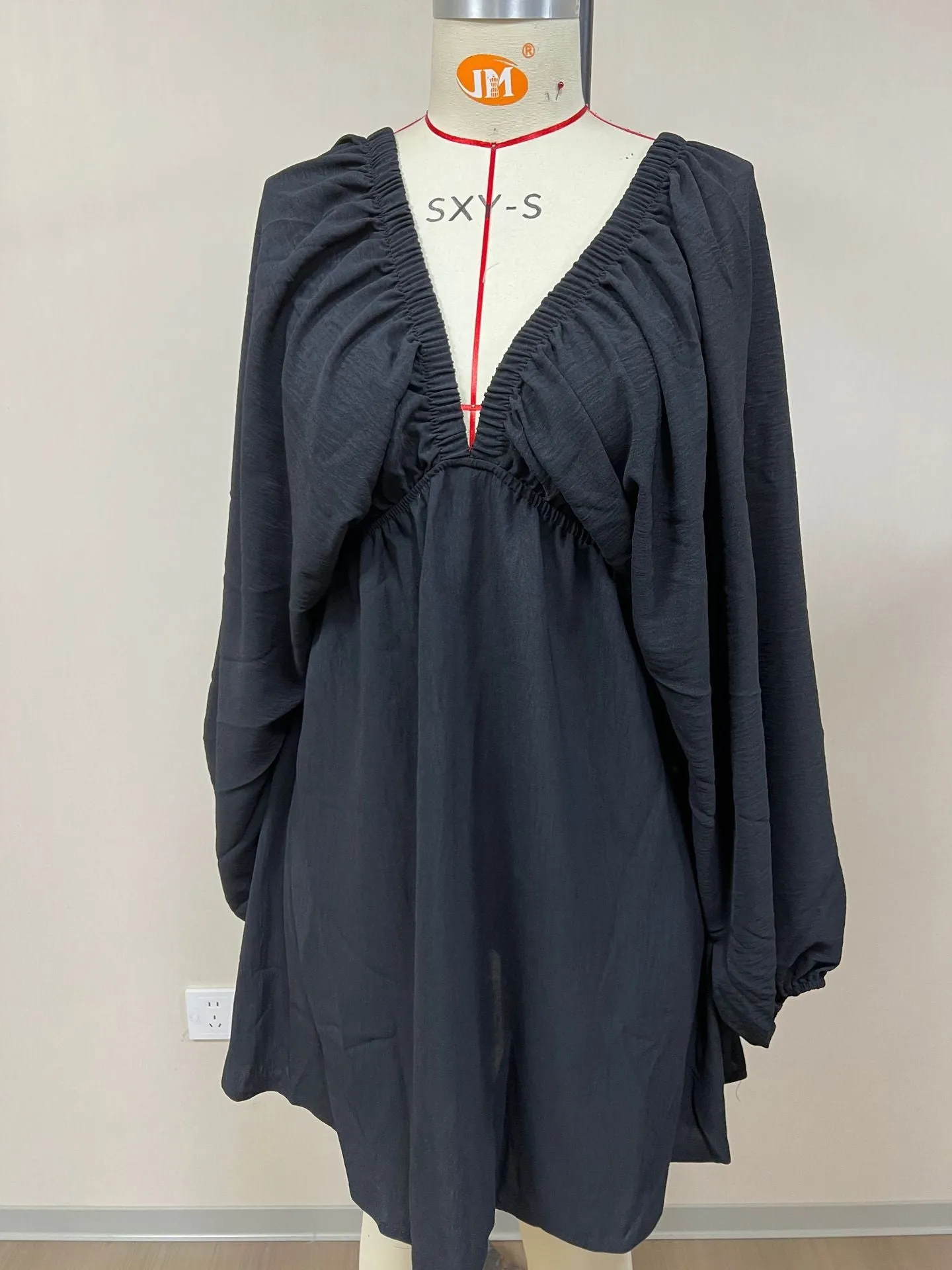 Women's v-neck long sleeve dress with puff sleeves and a flounced swing skirt in polyester fabric.