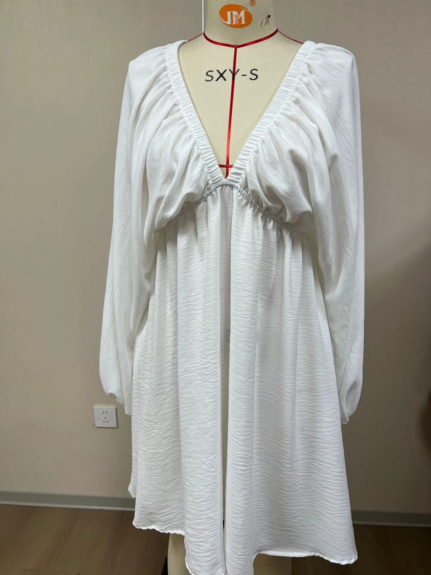 Women's v-neck long sleeve dress with puff sleeves and a flounced swing skirt in polyester fabric.
