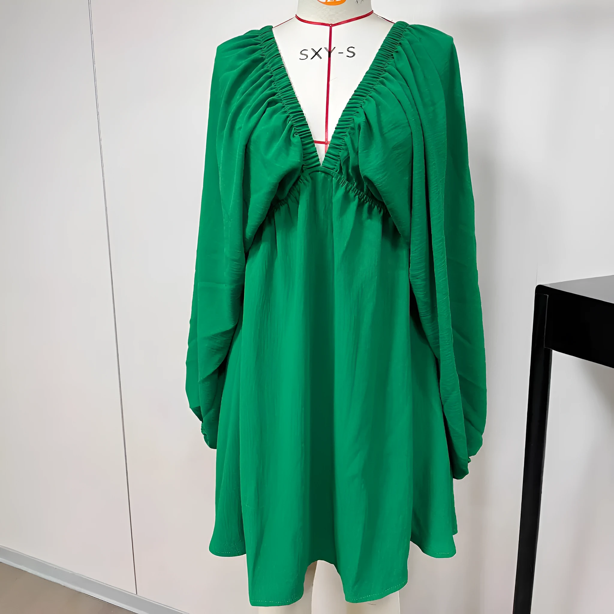 Women's v-neck long sleeve dress with puff sleeves and a flounced swing skirt in polyester fabric.