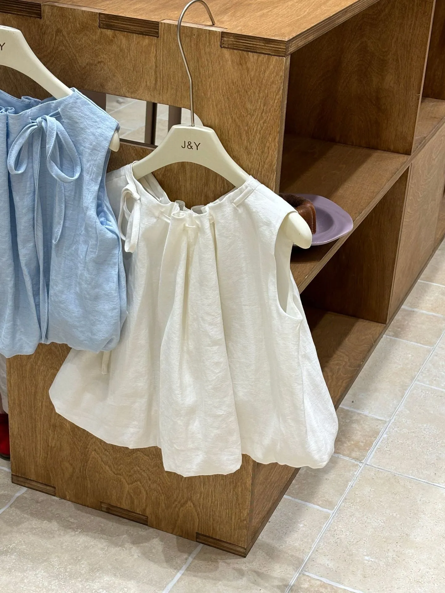 Milky white Korean style cotton drawstring shirt for girls with sleeveless design on light background