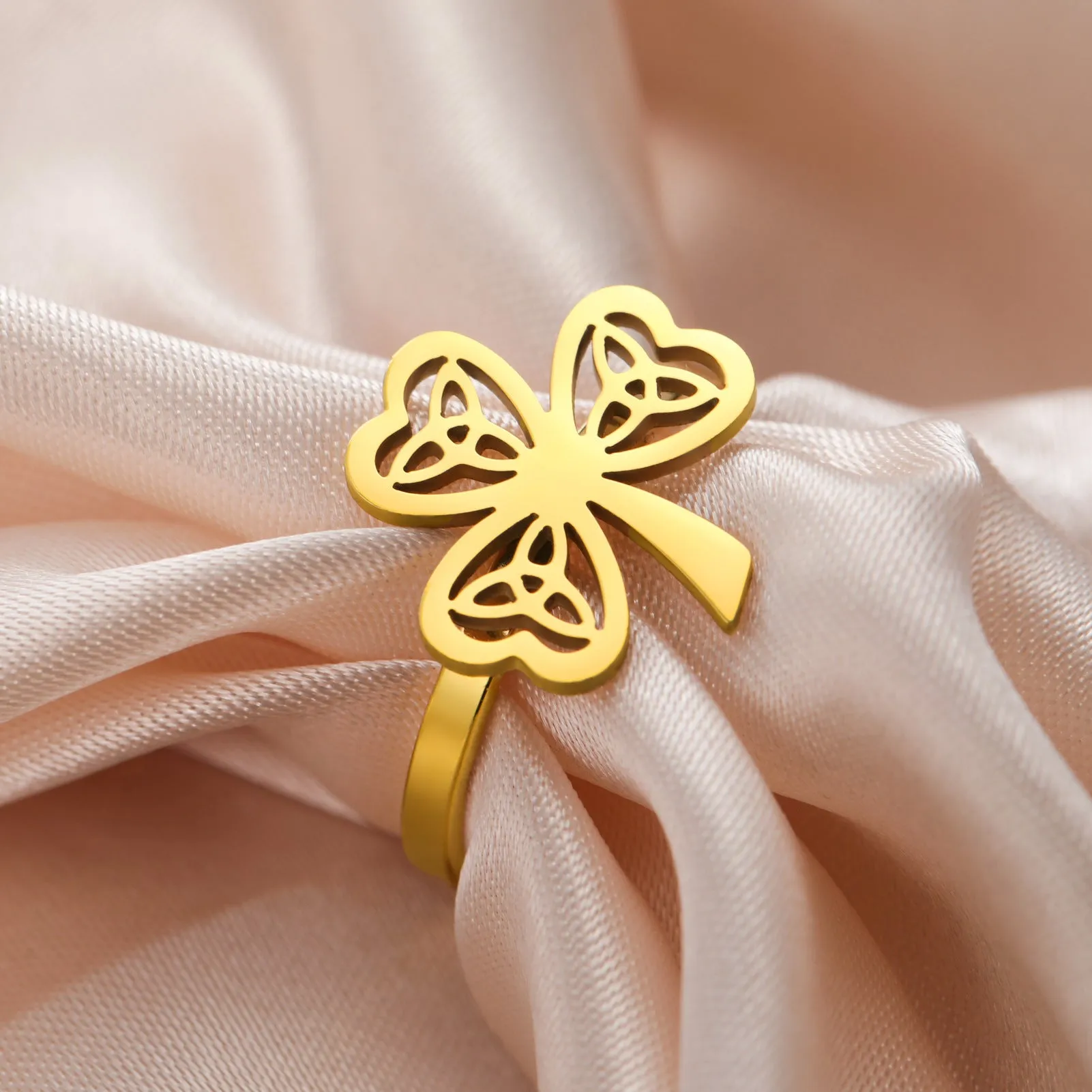 Stainless steel hollow ring with lucky symbol design in gold or steel finish