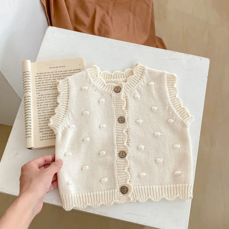 Children's knitted polka dot vest in apricot with single-breasted closure, featuring a sleeveless design for spring and autumn
