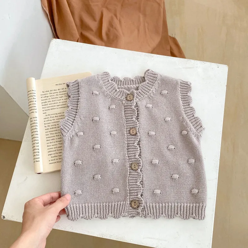 Children's knitted polka dot vest in apricot with single-breasted closure, featuring a sleeveless design for spring and autumn