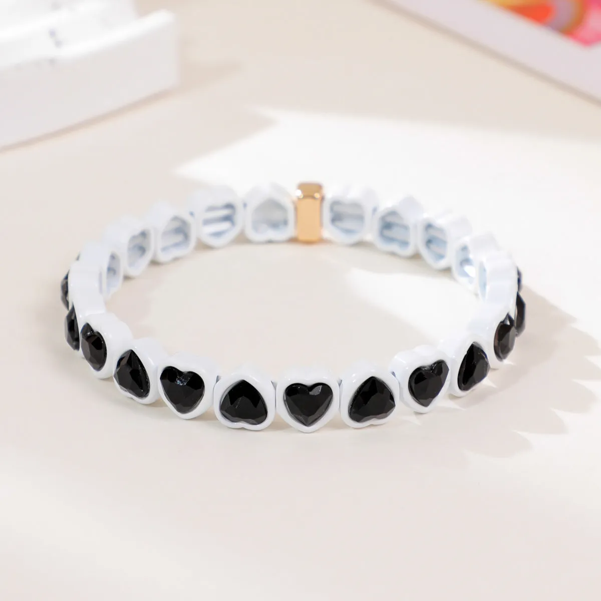 Rainbow coloured enamel heart pendant on stretch bracelet band