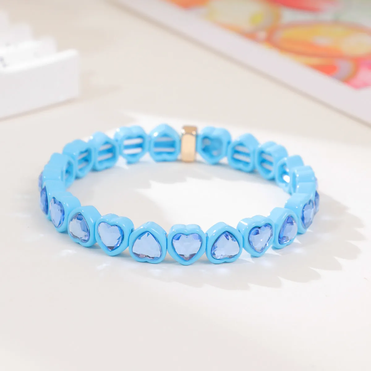 Rainbow coloured enamel heart pendant on stretch bracelet band