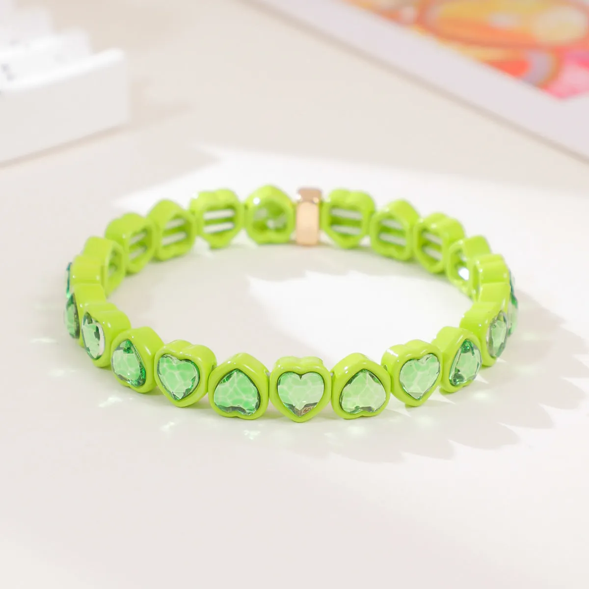 Rainbow coloured enamel heart pendant on stretch bracelet band