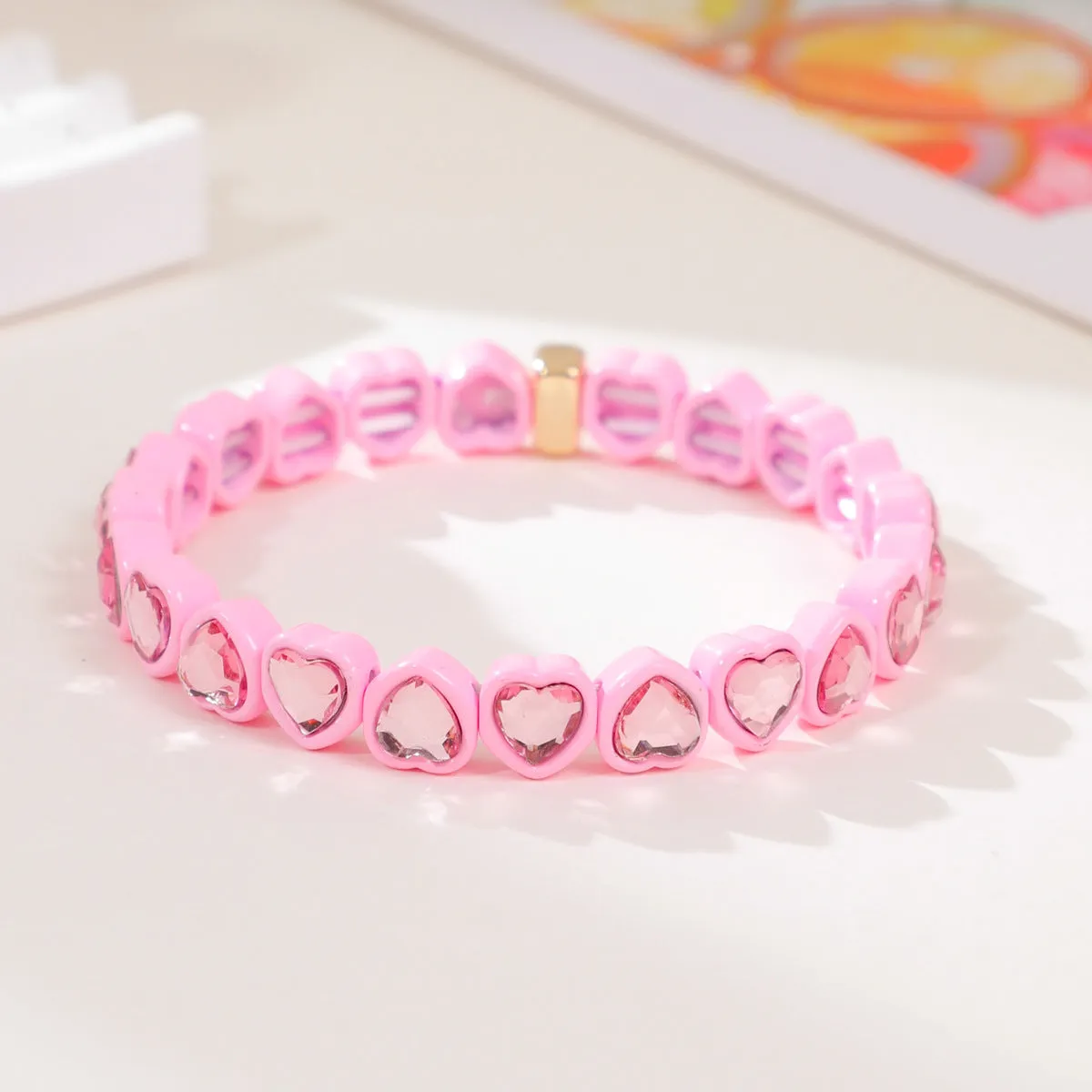 Rainbow coloured enamel heart pendant on stretch bracelet band
