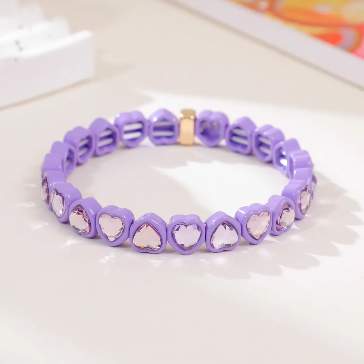 Rainbow coloured enamel heart pendant on stretch bracelet band