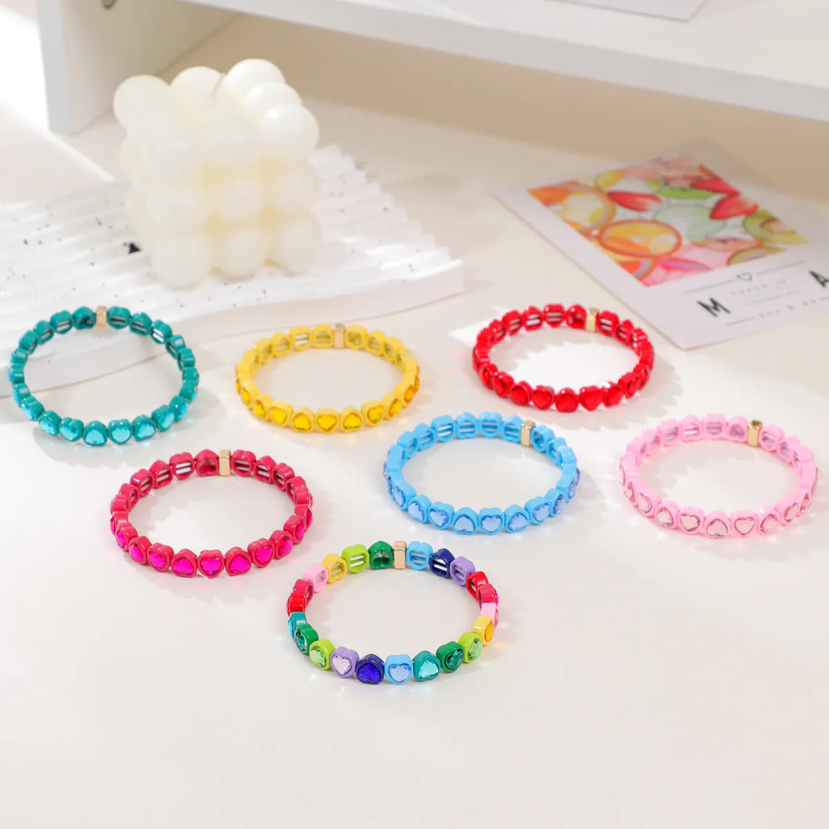 Rainbow coloured enamel heart pendant on stretch bracelet band