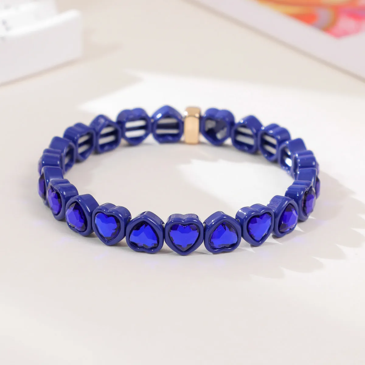 Rainbow coloured enamel heart pendant on stretch bracelet band