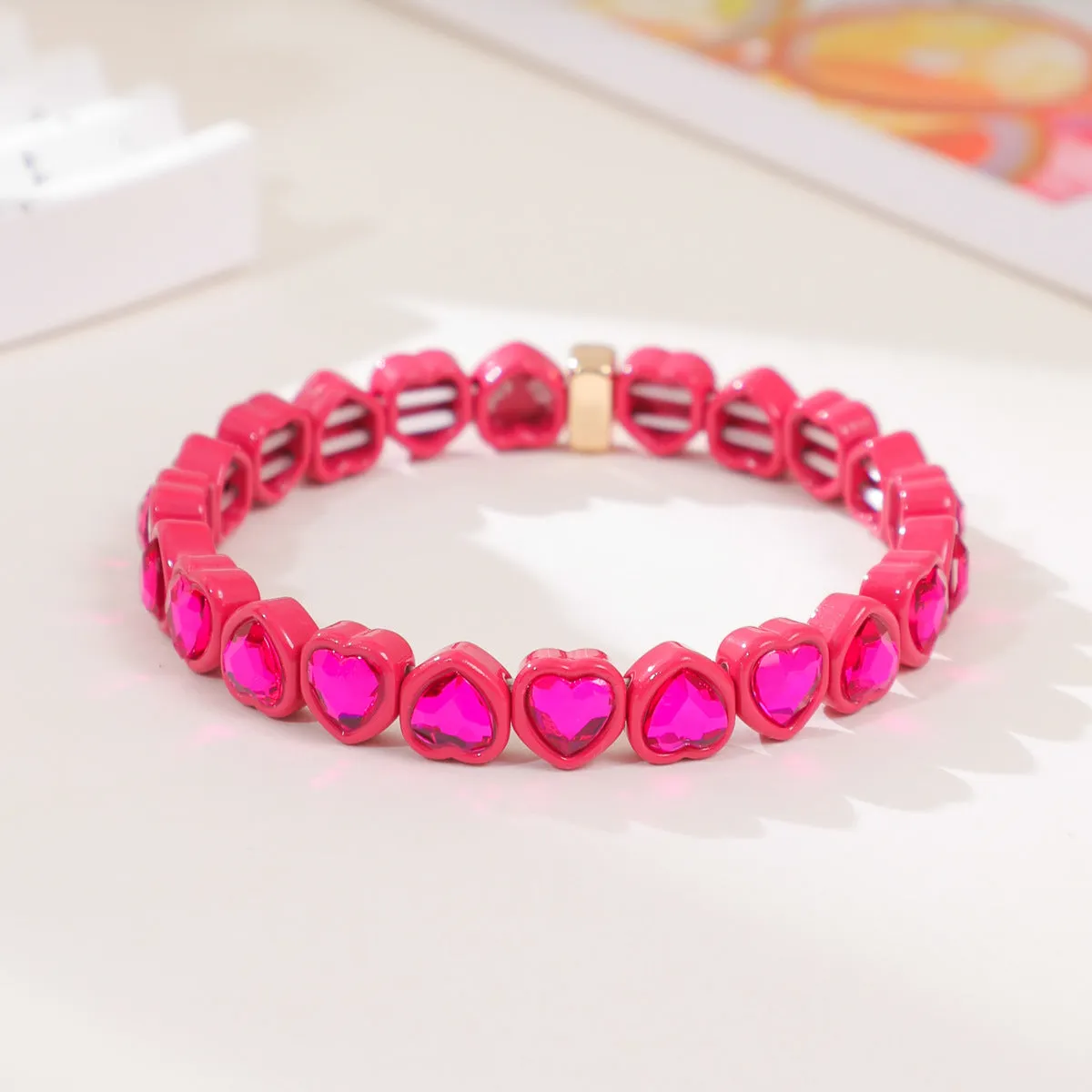 Rainbow coloured enamel heart pendant on stretch bracelet band