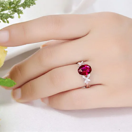 Women's butterfly ring with heart-shaped design in copper and rose gold plating, showing blue and red colour options