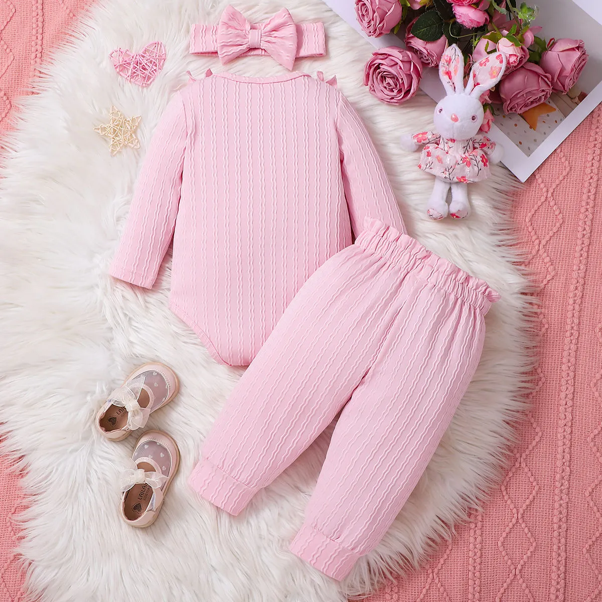 Pink baby girl three-piece set with ribbed frill long sleeve romper, pants, and matching headscarf on white background