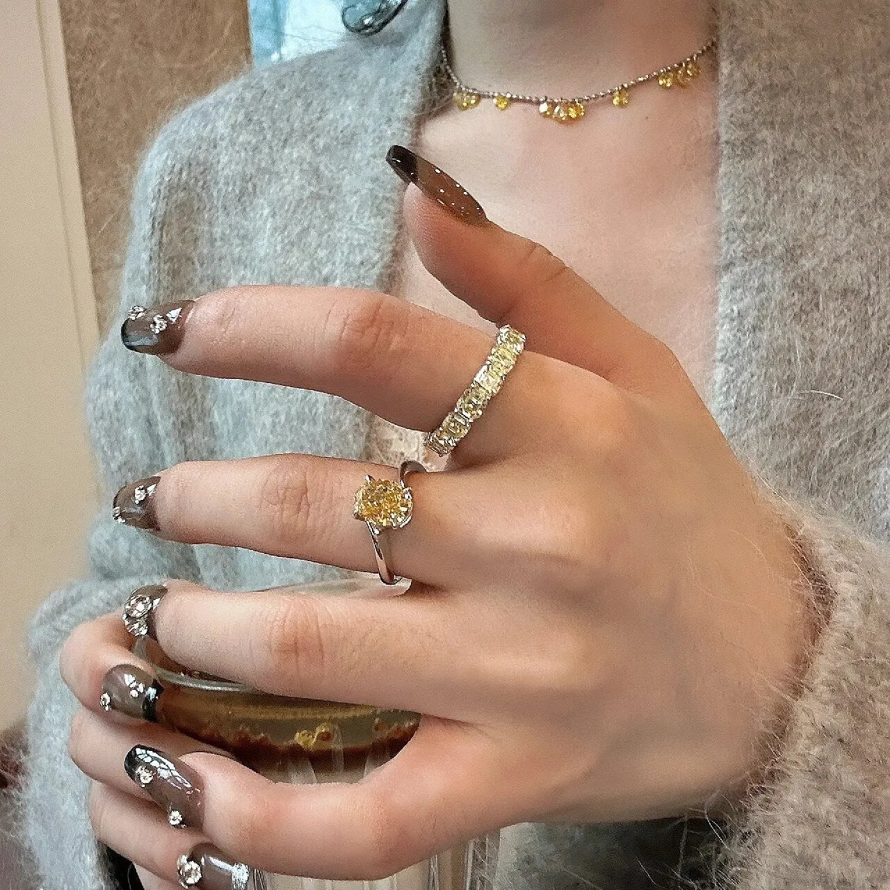Women's copper ring with a bright yellow crystal sugar finish on a finger.