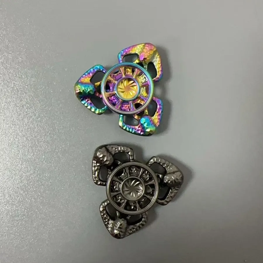 Flame Butterfly alloy metal rotating fingertip fidget gyro toy in colourful or space grey.