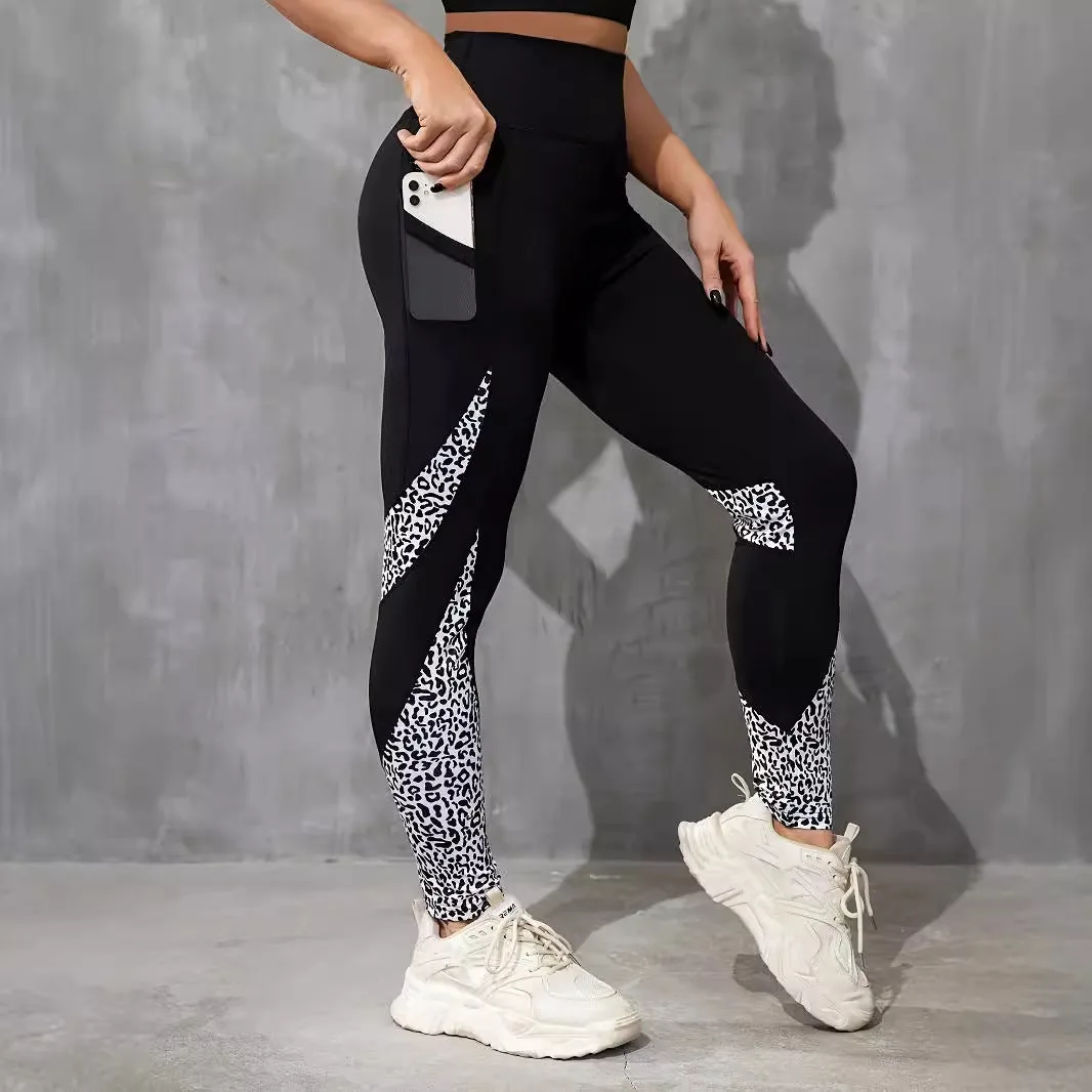 Black women's high-waisted yoga leggings with contrast patchwork design and side pocket.