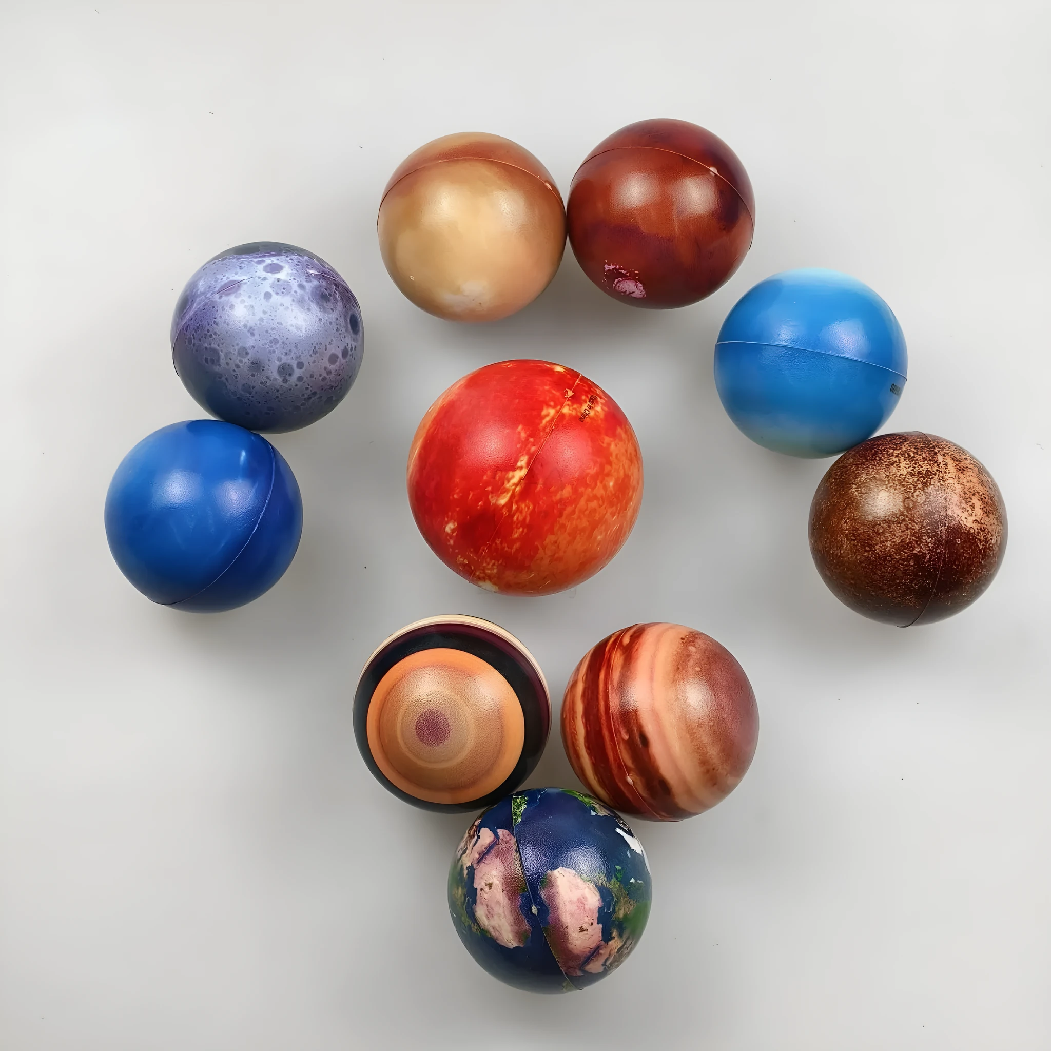 Set of eight solar system planet stress balls plus moon and sun in soft PU foam on white background