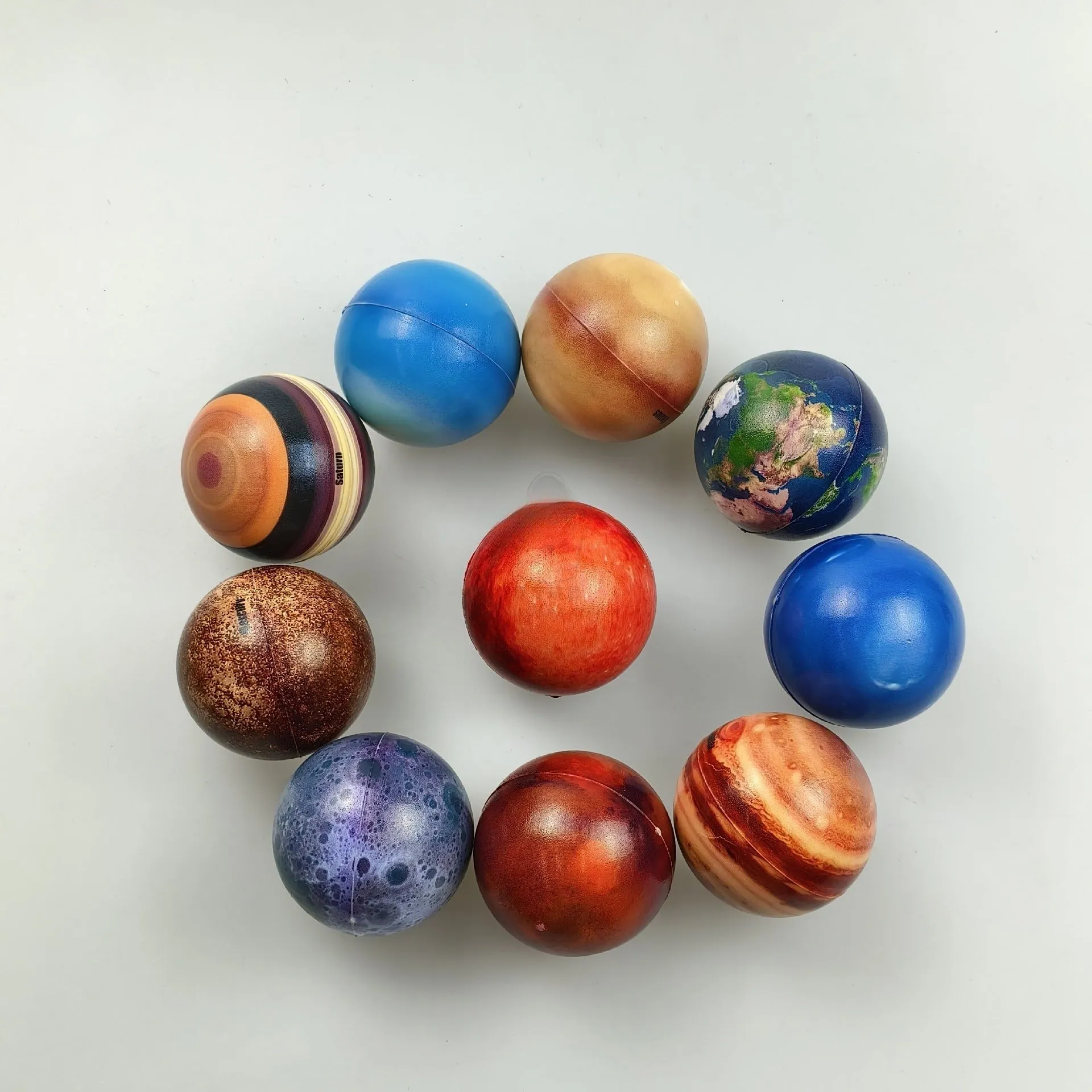 Set of eight solar system planet stress balls plus moon and sun in soft PU foam on white background