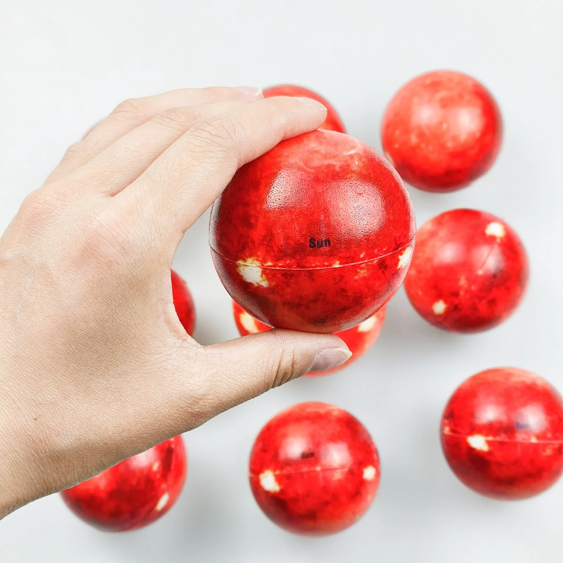 Set of eight solar system planet stress balls plus moon and sun in soft PU foam on white background